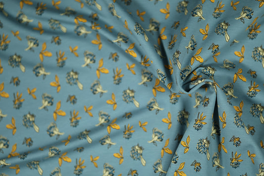 Baumwollstoff mit Motiv: gelbe blätter auf himmelblau – weich & kindgerecht.
