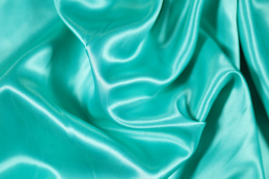 Glänzender Dekorstoff türkis grün für Tischdeko