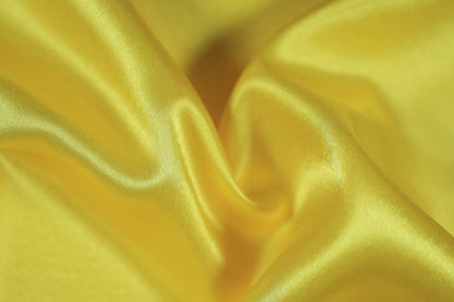 Leuchtender gelber Satin Stoff für Dekoration & Mode