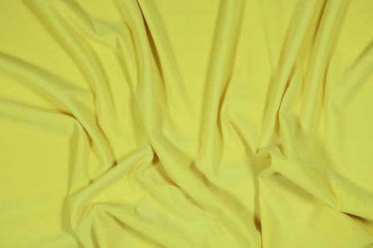 Elastischer Jersey in einem hellen, sonnigen Gelbton für Sommerbekleidung