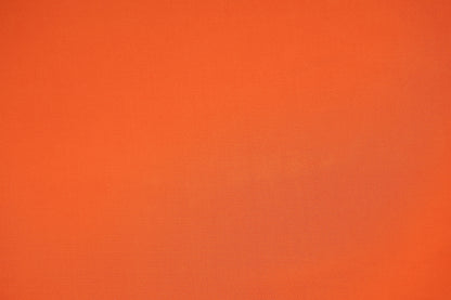 Weich fließender Jersey in der Farbe Mandarine, der die feine Textur zeigt