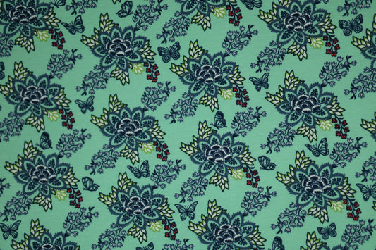 Verspielter Baumwollstoff mit floralen Ornamenten auf Mint.