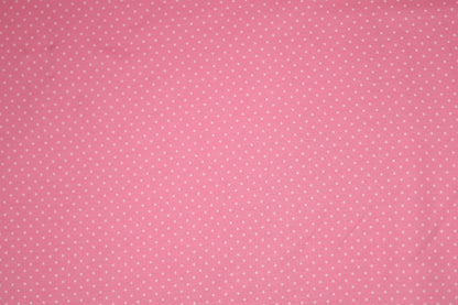 Zartes Punktmuster auf rosa Baumwollstoff – ideal für Baby- und Kinderkleidung.